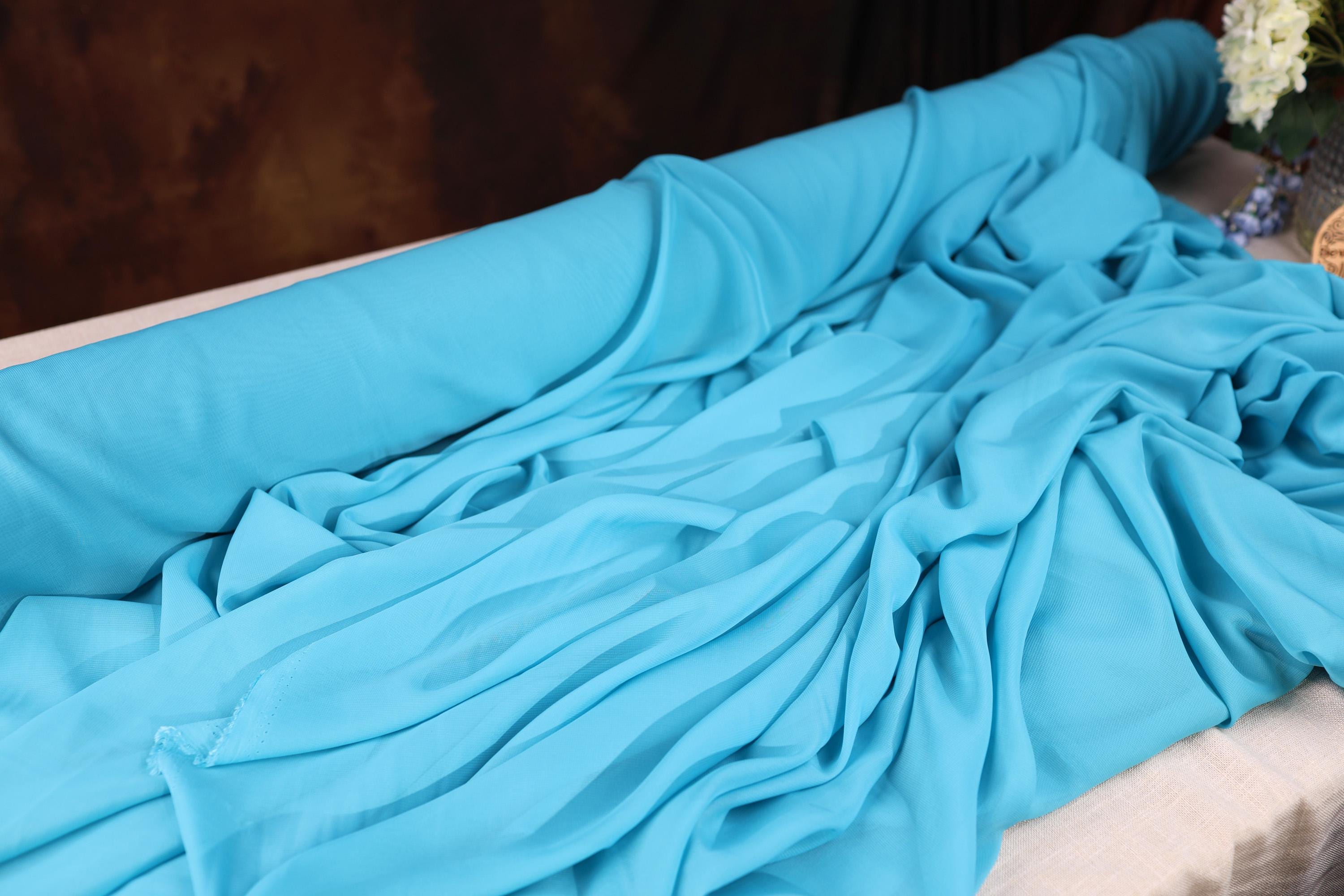 a blue sheet is laying on a bed