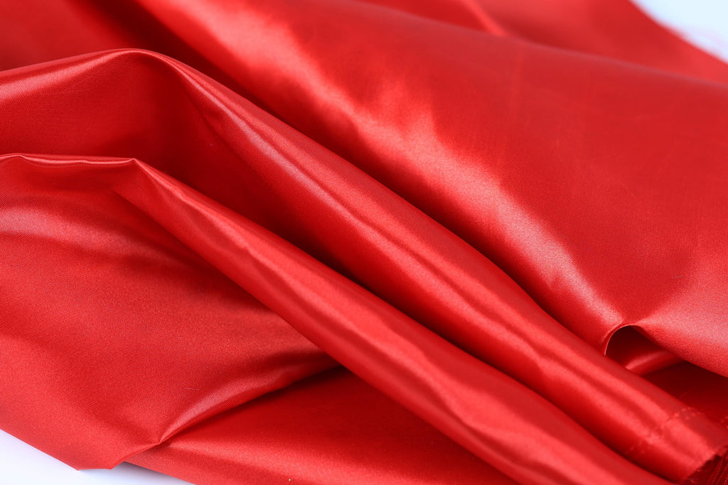 a close-up view of a shiny, red satin fabric.