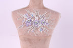 A mannequin with a delicate floral embroidered on its shoulder.