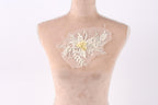 A mannequin torso with a delicate, floral-patterned fabric attached to it.