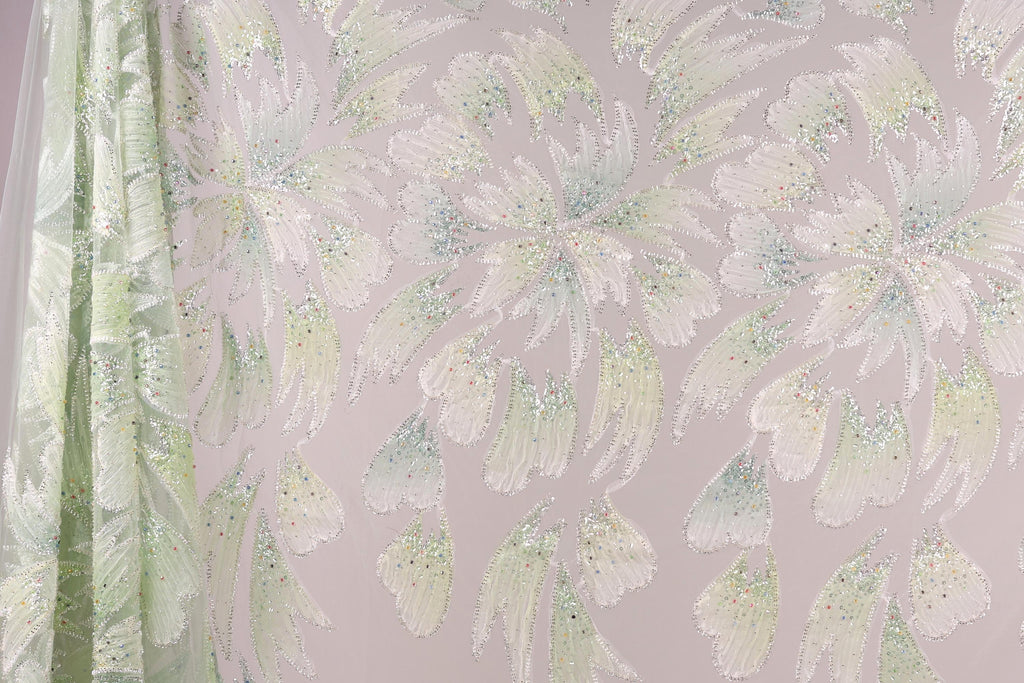 a pattern of white and green flowers with glittering details, creating a visually striking and intricate design.
