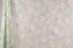 a pattern of white and green flowers with glittering details, creating a visually striking and intricate design.