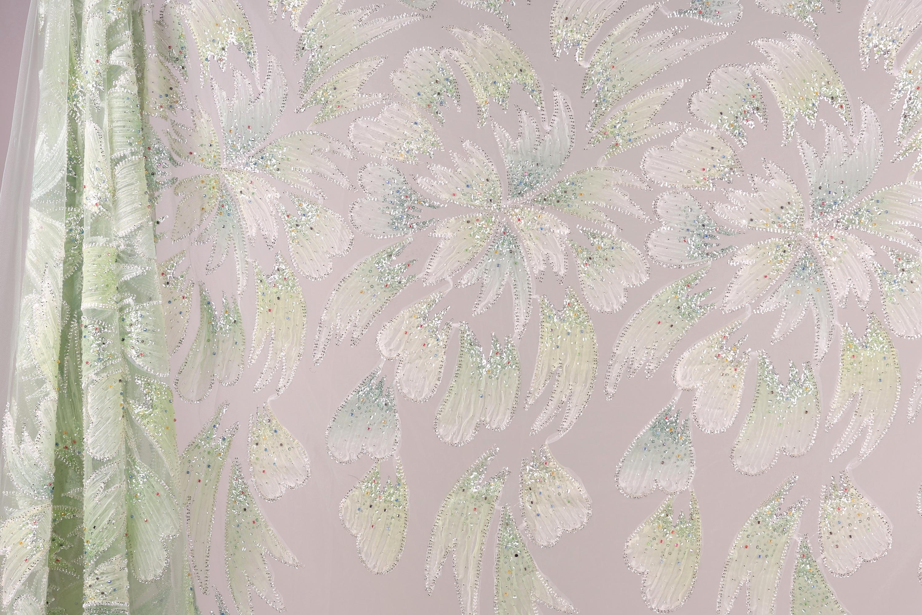 a pattern of white and green flowers with glittering details, creating a visually striking and intricate design.