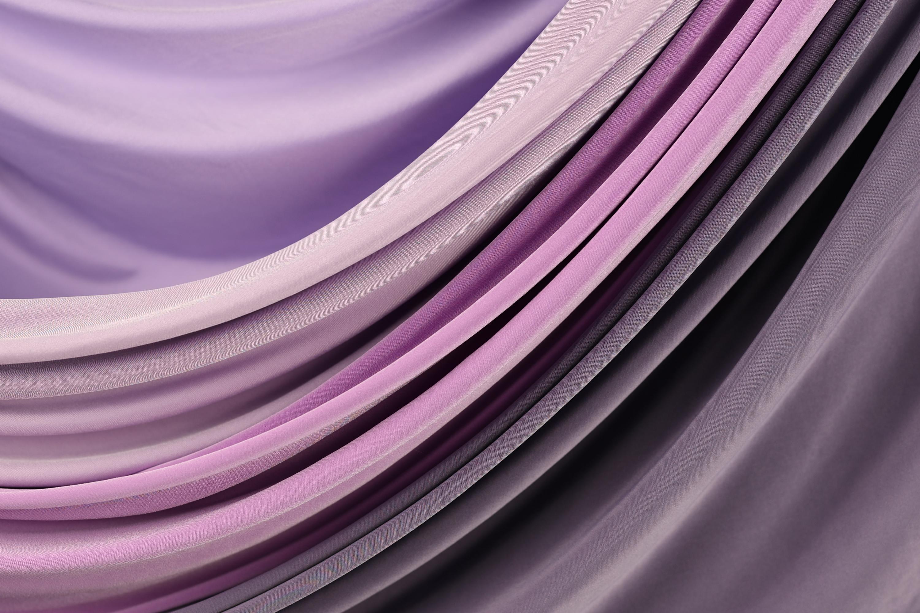 a close-up view of a fabric with a gradient of purple and pink colors, creating a visually appealing and textured appearance.