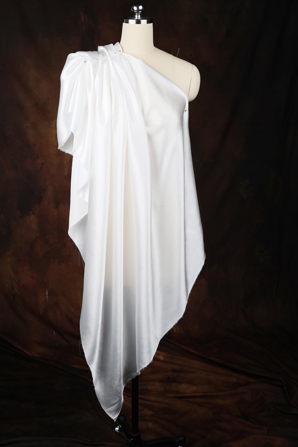 a white dress on a mannequin on a black background