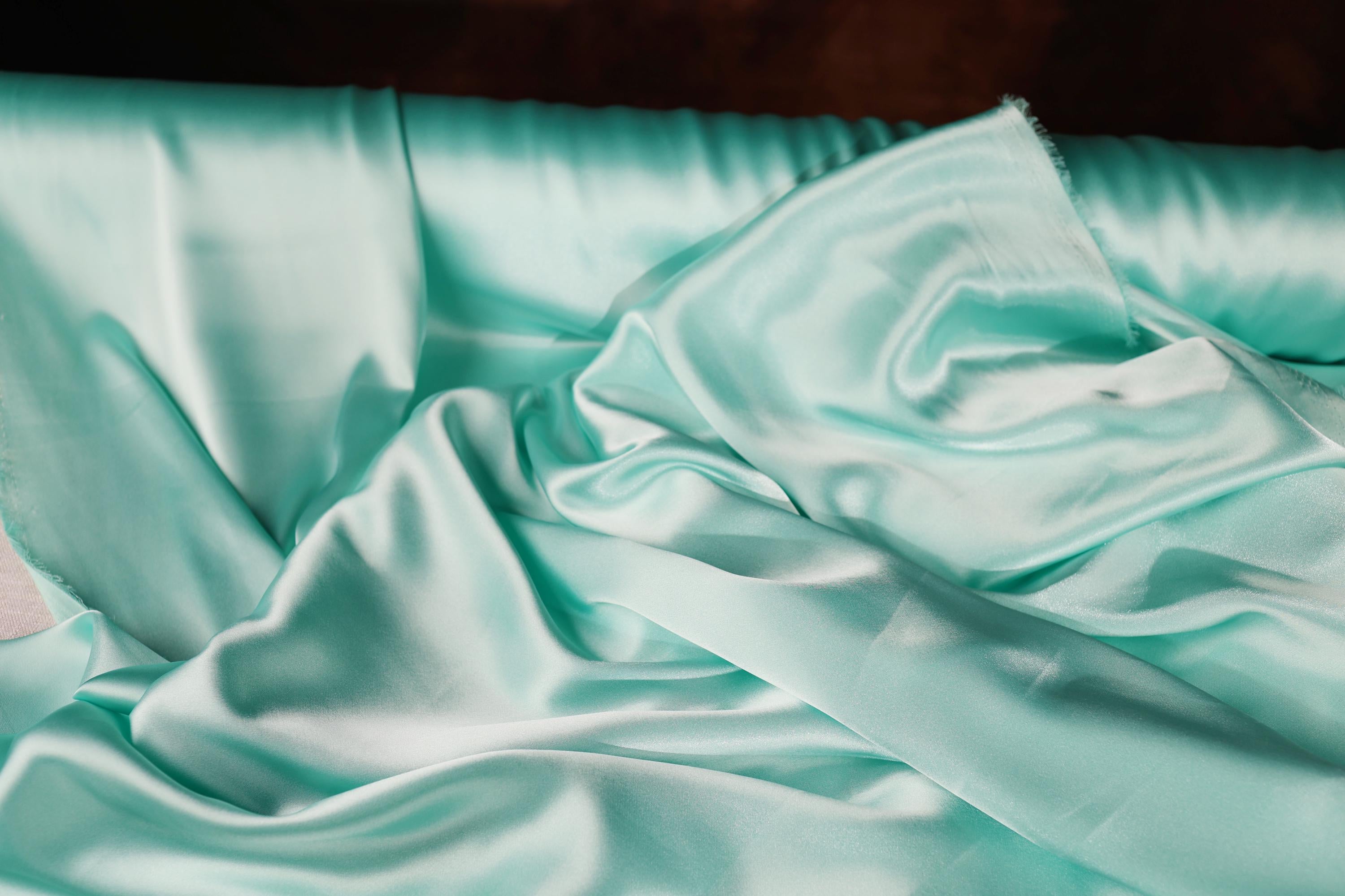 a close up of a bed with a sheet on it