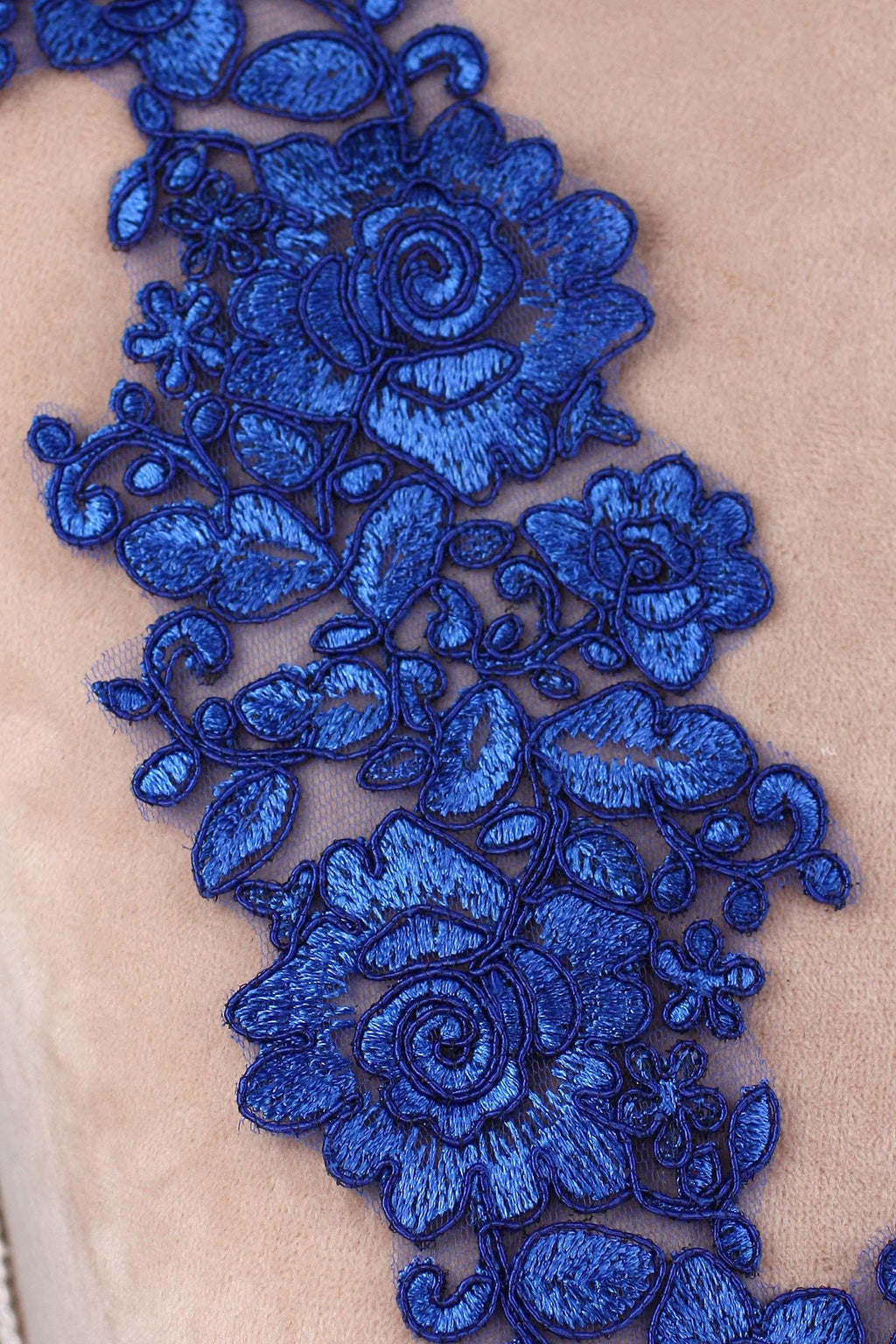 a close up of a piece of cloth with blue flowers on it