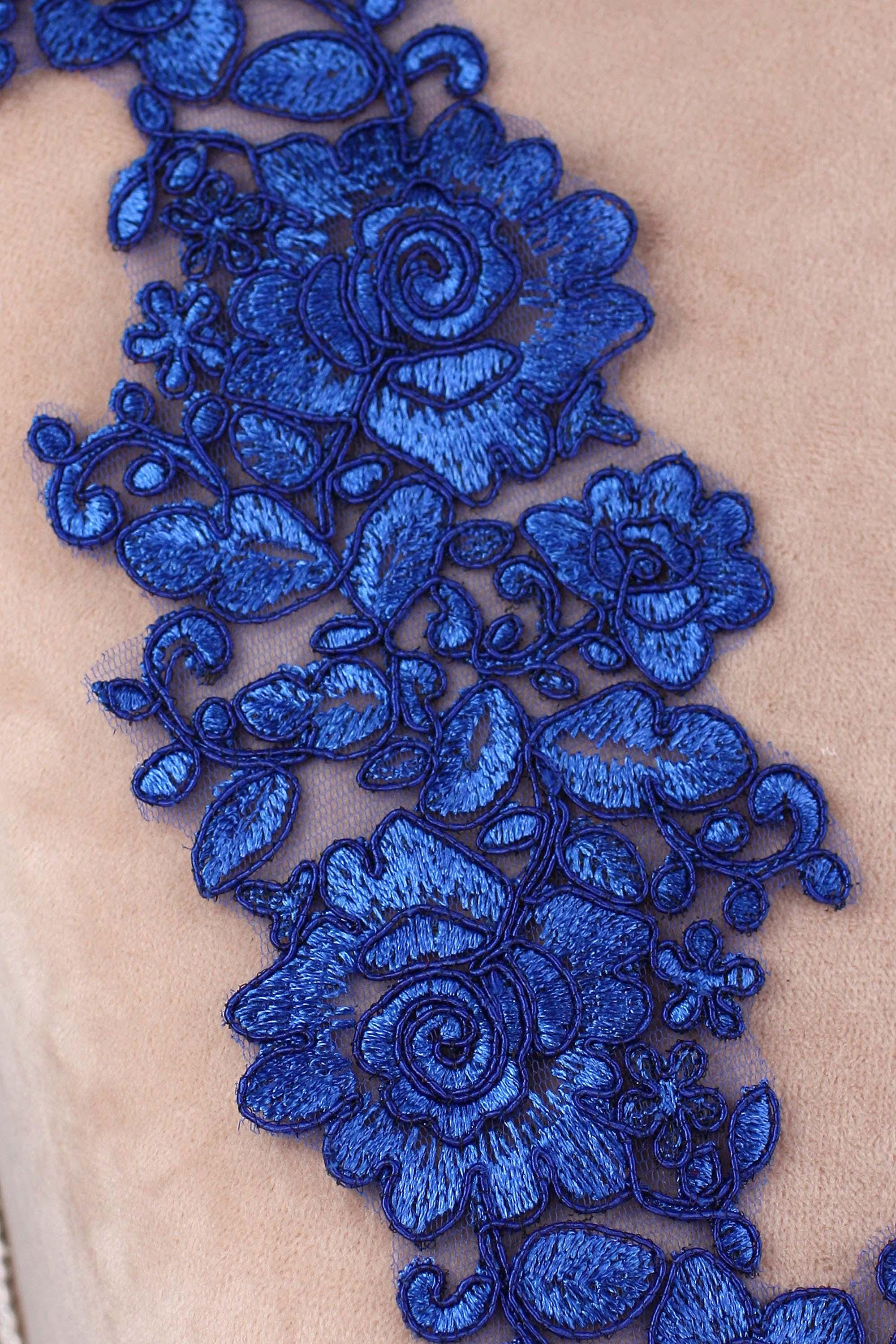 a close up of a piece of cloth with blue flowers on it