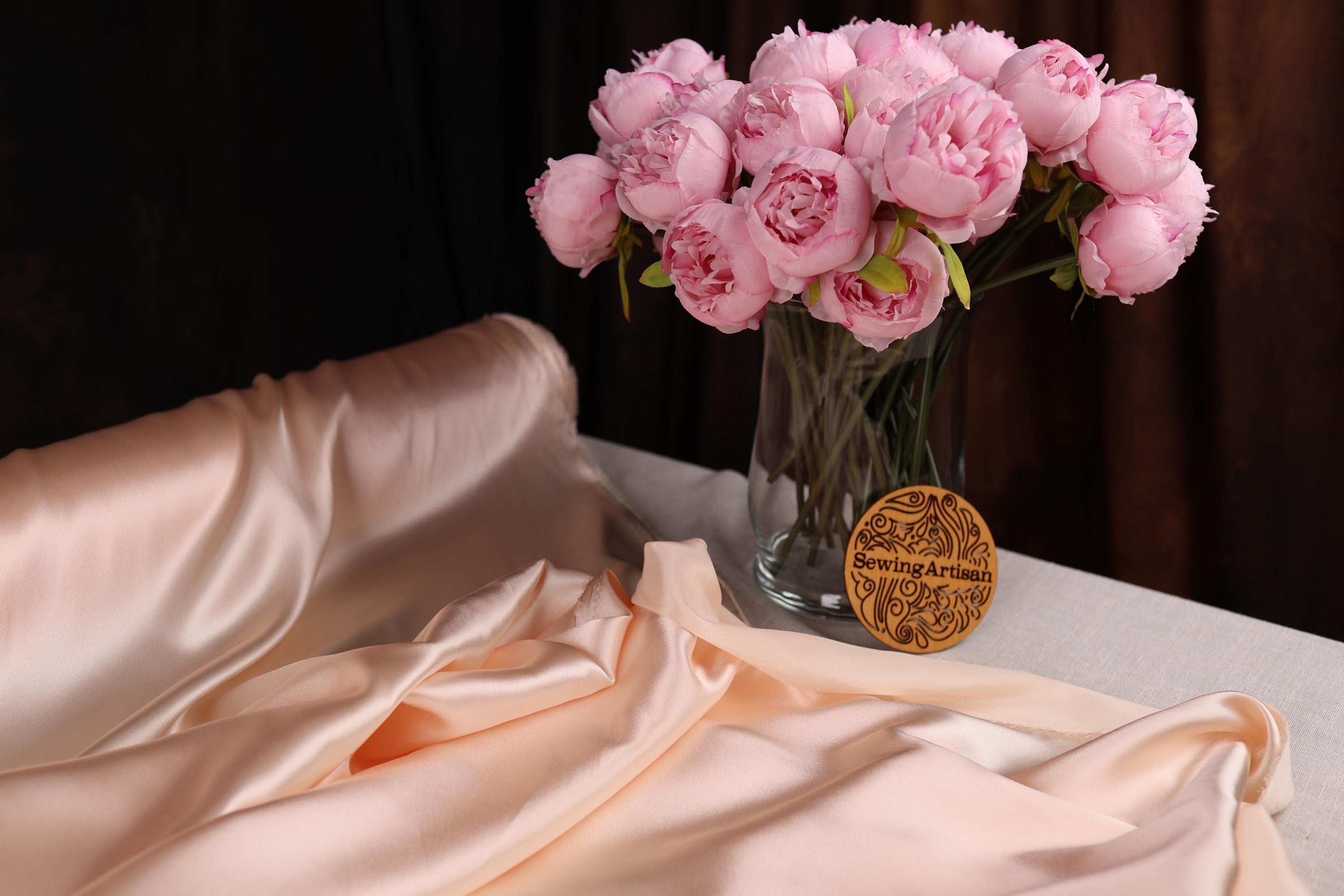 a vase filled with pink flowers on top of a table