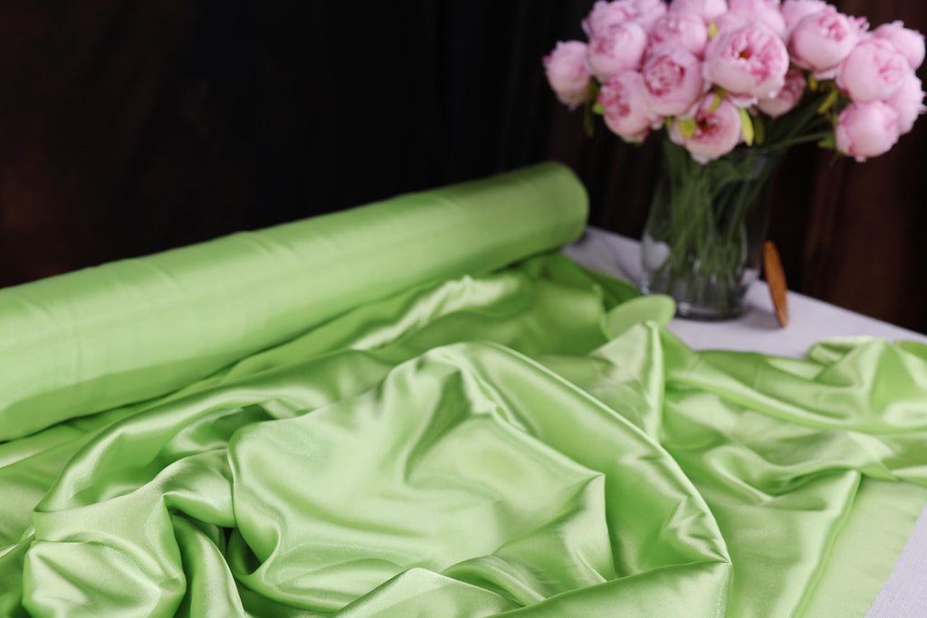 a vase filled with pink flowers sitting on top of a table