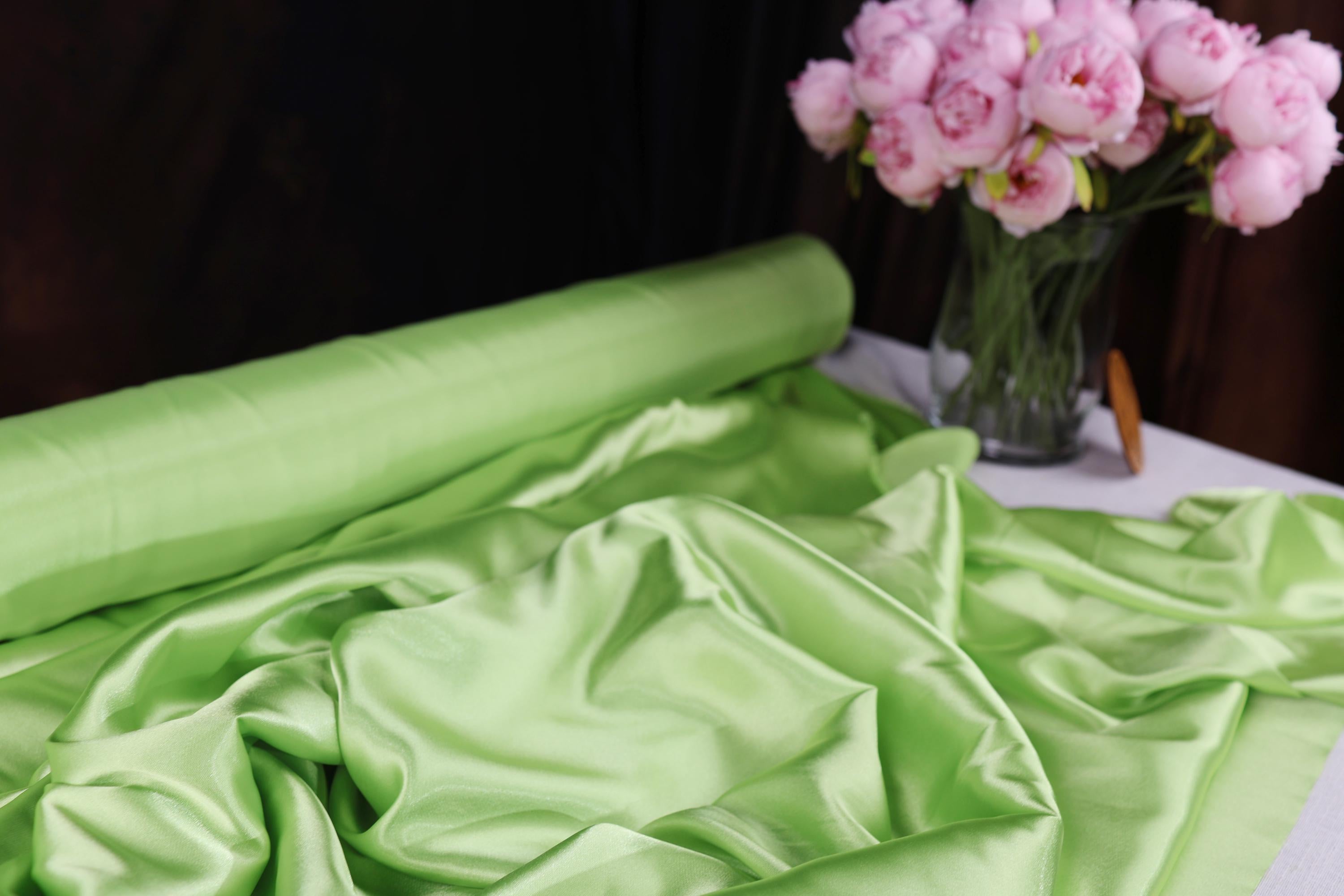 a vase filled with pink flowers sitting on top of a table