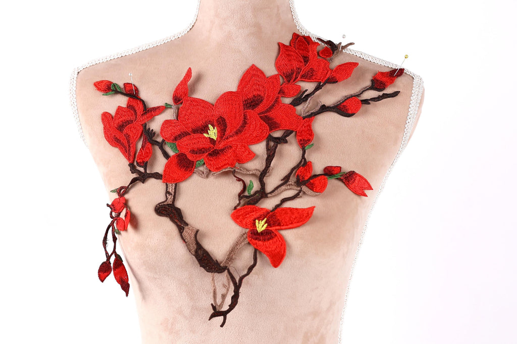 a mannequin with a red flower embroidered on its bust.