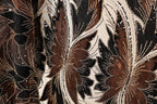 a close-up view of a fabric with a floral pattern, showcasing intricate details and textures.