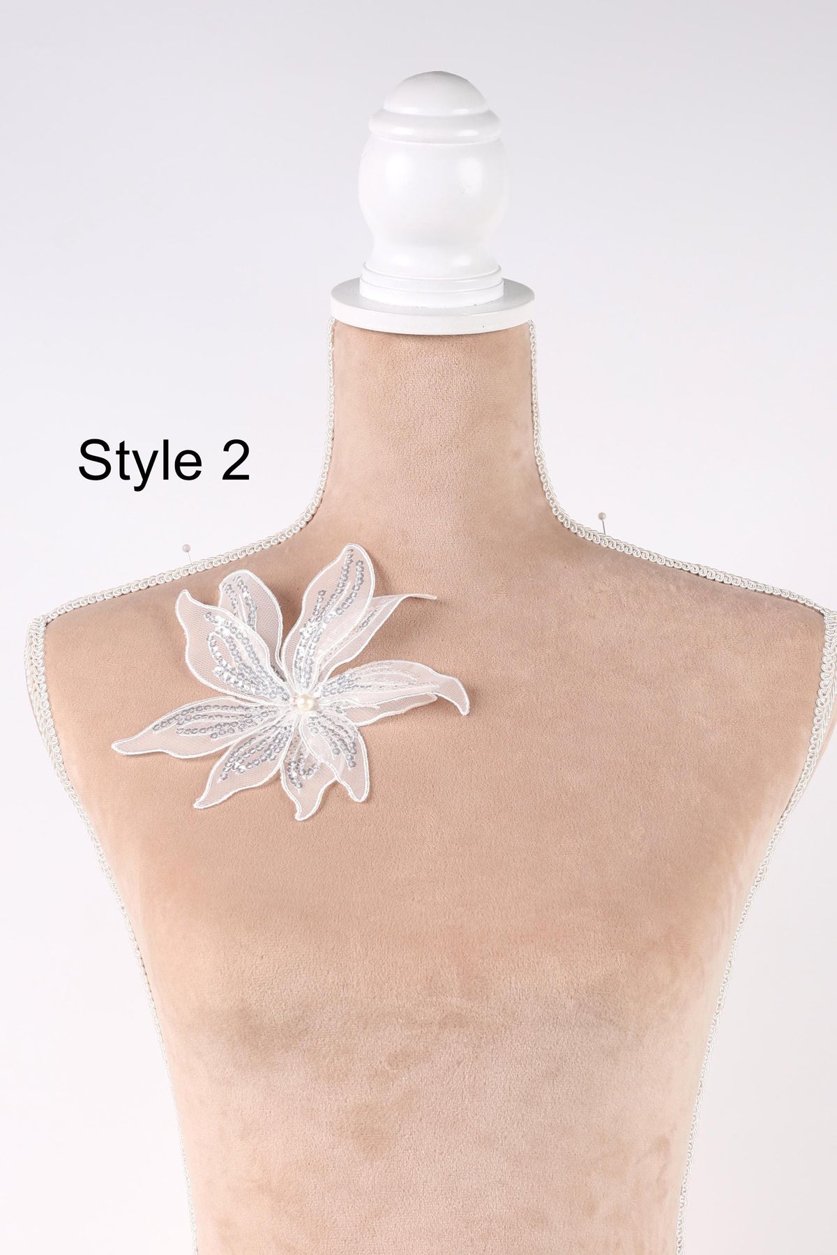 A mannequin with a white flower on its shoulder, labeled as "Style 2".