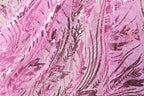 The image is a close-up view of a fabric with a pink and black sequin pattern. The fabric appears to be made of sheer material, giving it a delicate and intricate appearance. The pattern consists of various lines and shapes, creating a visually striking and textured design.