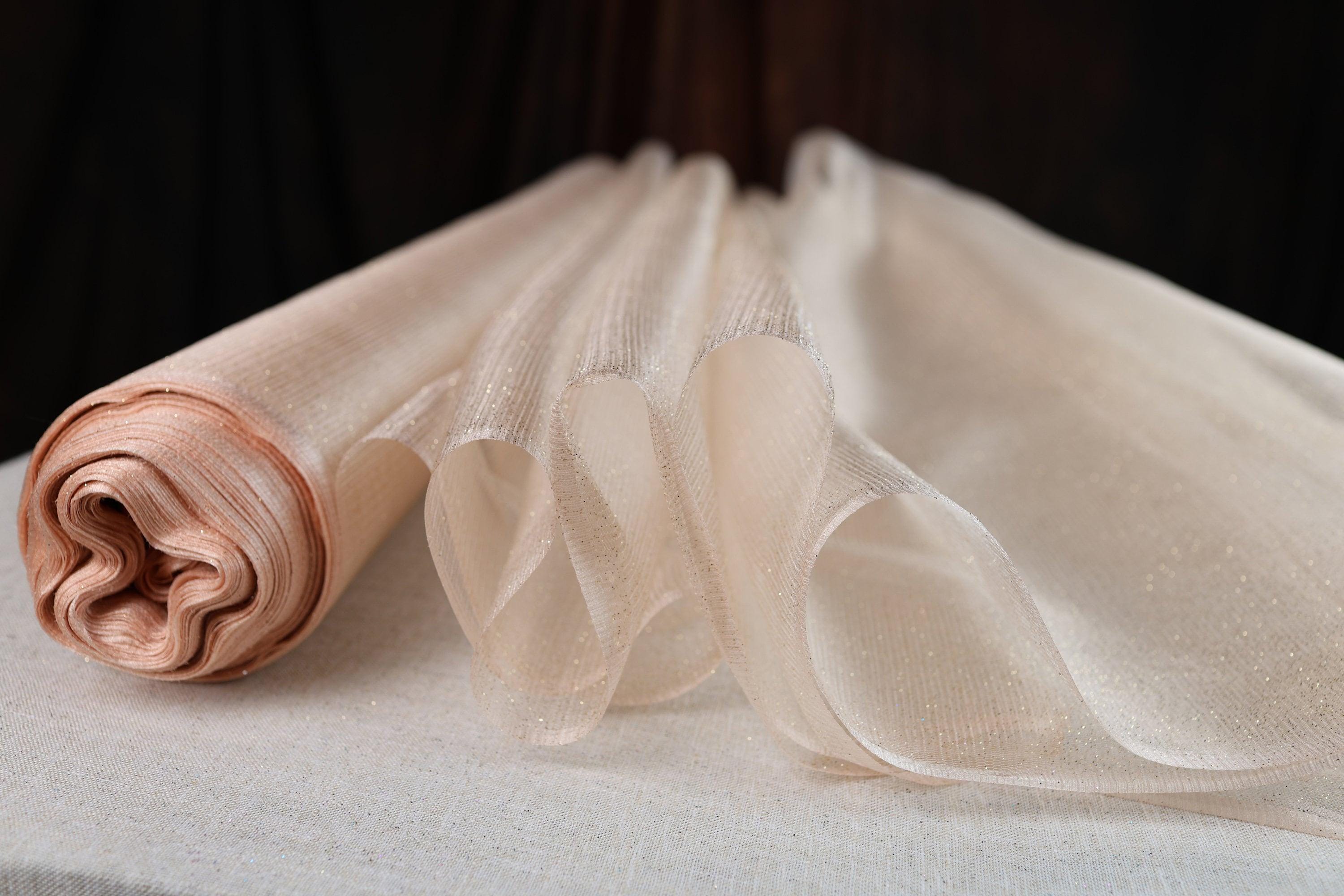 a roll of fabric sitting on top of a bed