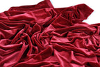 a close-up view of a crumpled, red velvet fabric.
