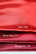 three different shades of red fabric, with the topmost shade being a vibrant red, the middle shade being a slightly darker red, and the bottom shade being a more muted red. The text labels the colors as "Red 190", "Wine Red 214", and "Burgundy 232".