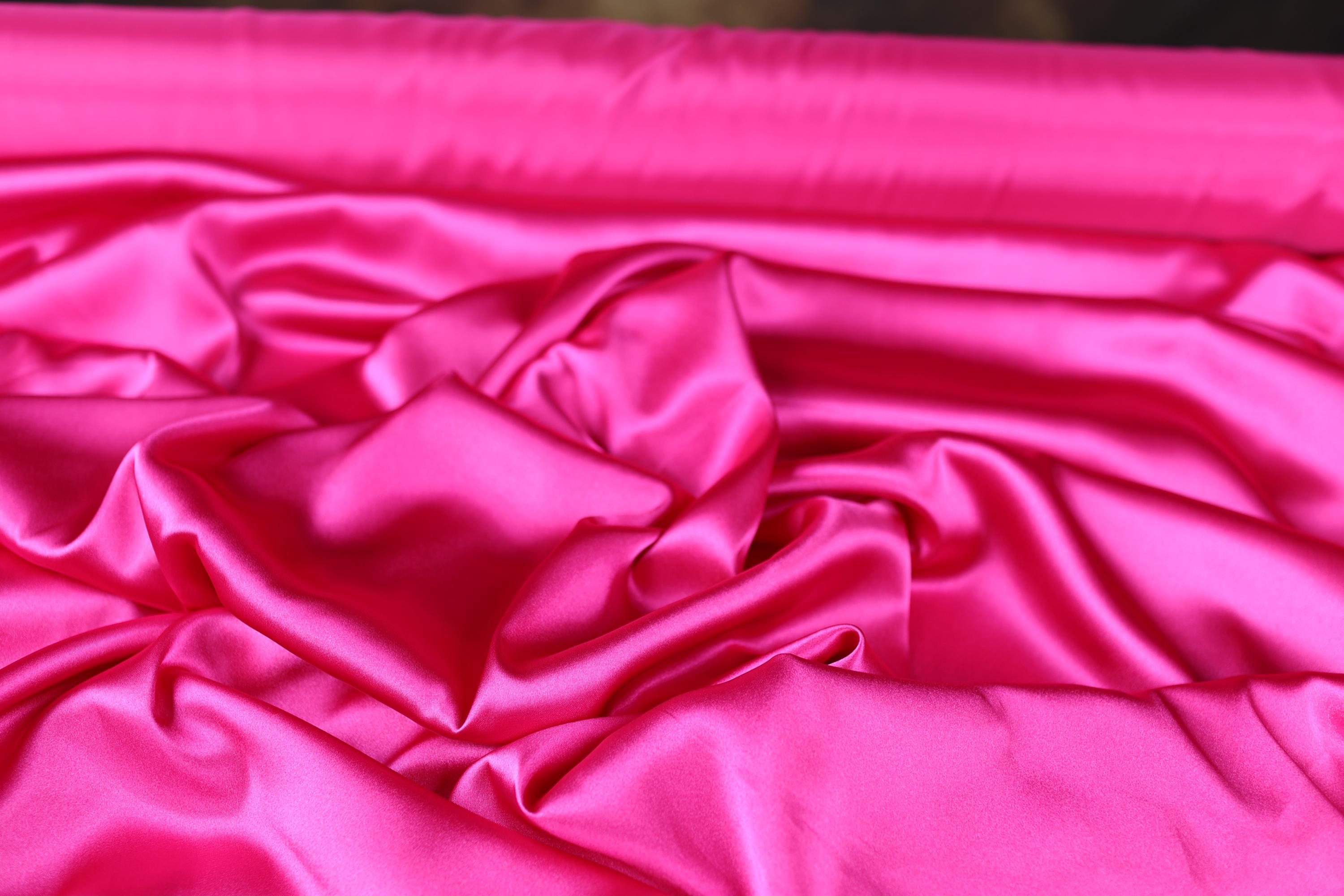 a close up of a pink satin material