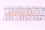 a clear ruler with a pink floral pattern placed on top of it.