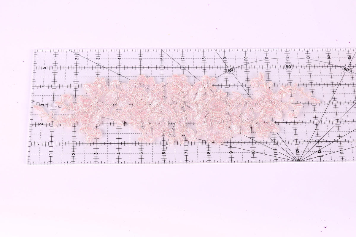 a clear ruler with a pink floral pattern placed on top of it.
