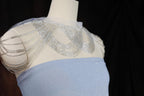 a dress on a mannequin with beads on it