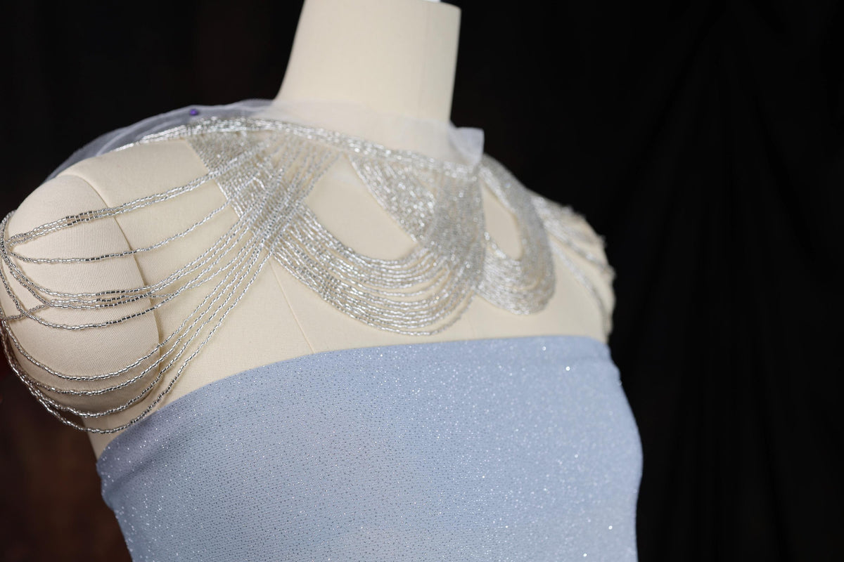 a dress on a mannequin with beads on it