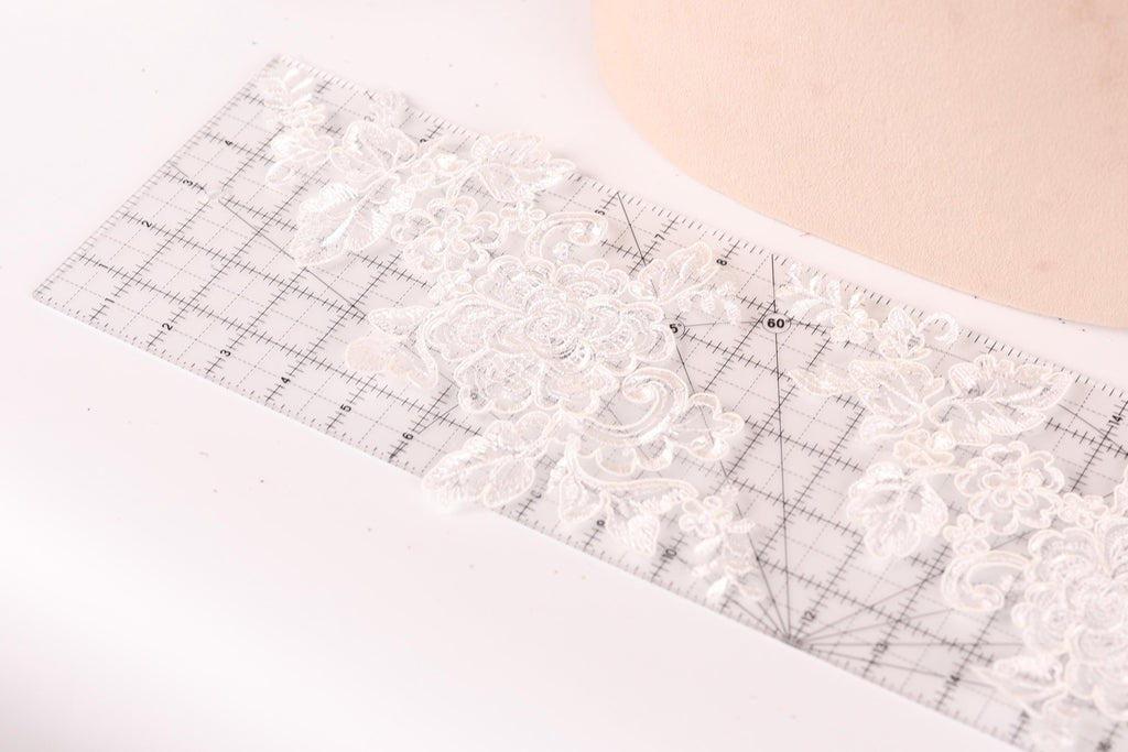a clear ruler with a floral pattern on it, placed on a white surface.