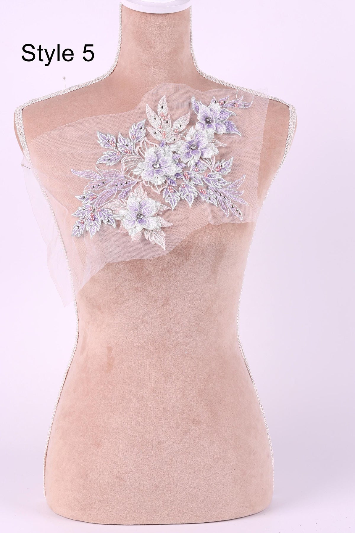 A mannequin with a floral embroidered patch on its bust.