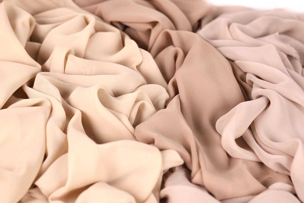 a close-up view of a crumpled fabric with a light brown or beige color.