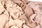 a close-up view of a crumpled fabric with a light brown or beige color.