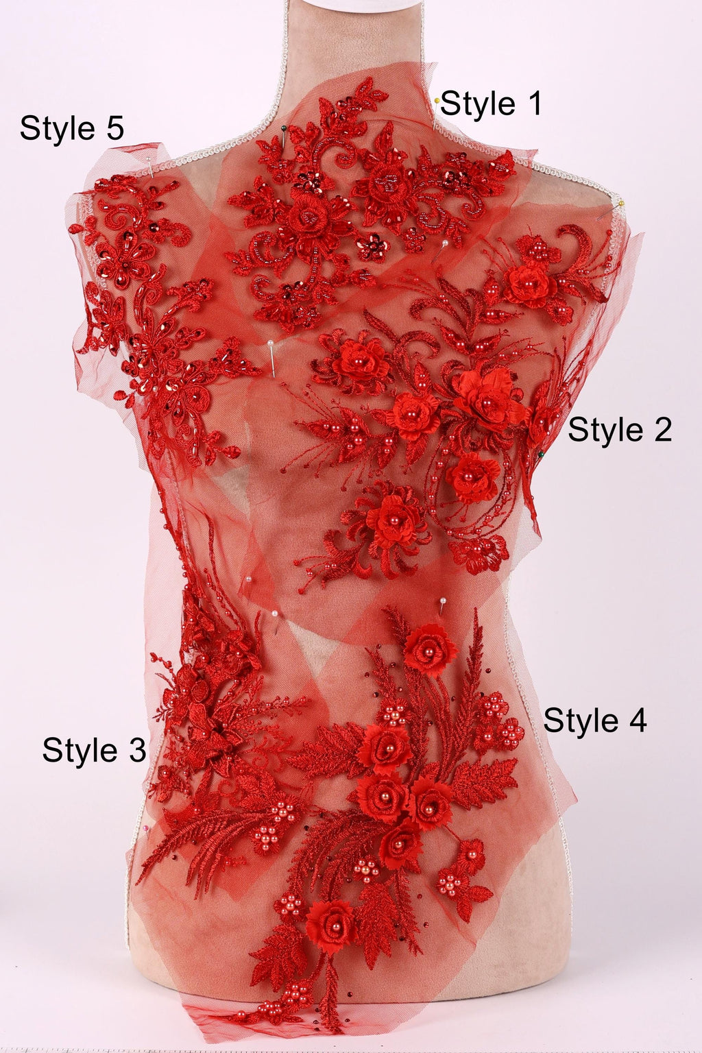 A mannequin with a red floral dress on it, featuring various styles of the dress.