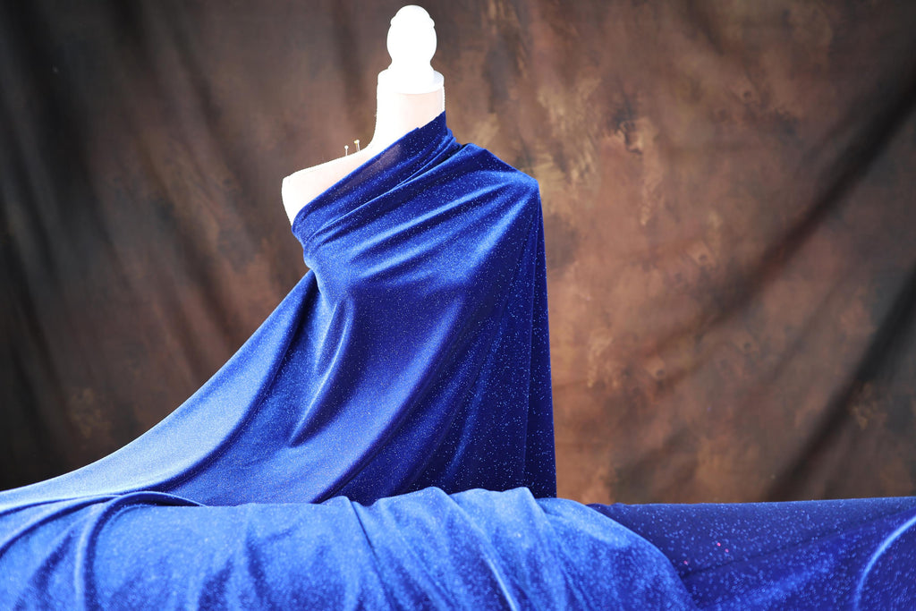 a mannequin dressed in a blue cloth draped over a bed