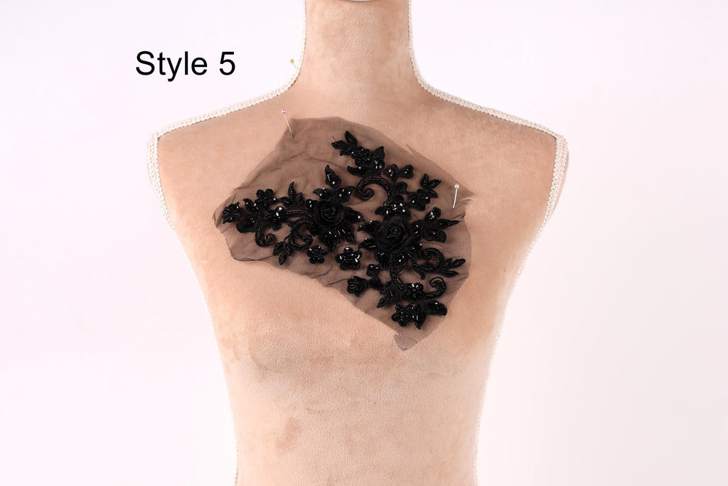 A mannequin with a decorative black lace piece on its chest.