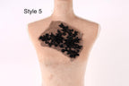 A mannequin with a decorative black lace piece on its chest.