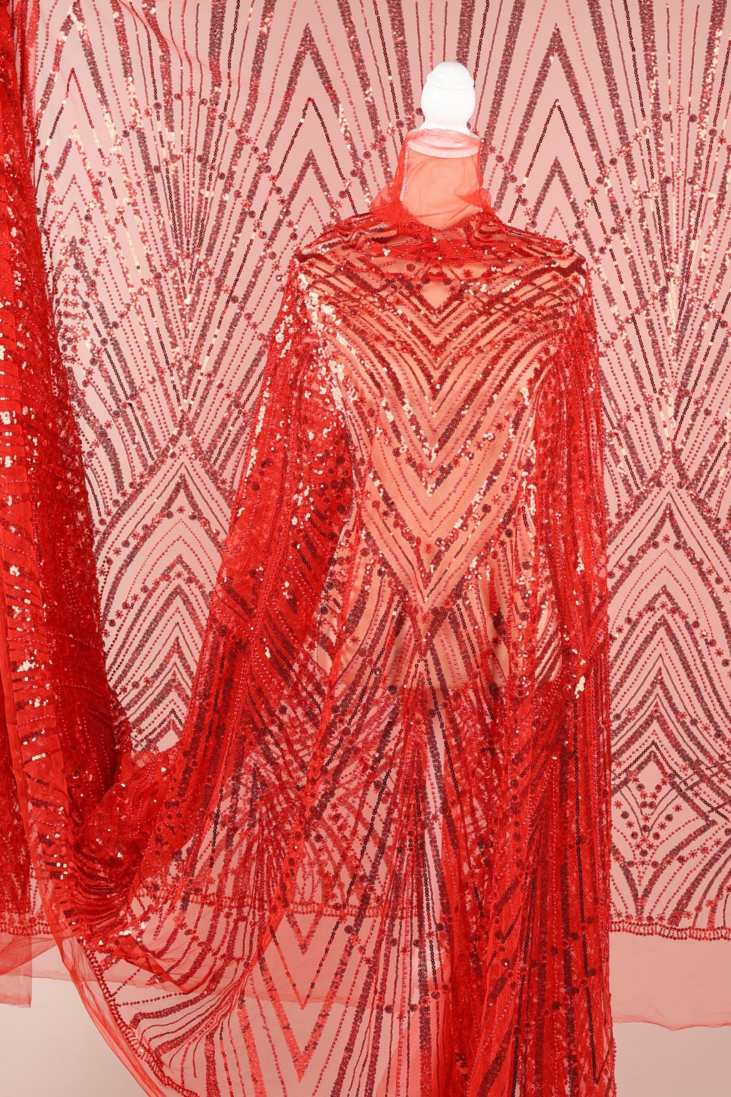 a red sequin fabric with a geometric pattern, creating a visually striking and eye-catching design.