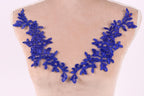a mannequin torso with a decorative blue lace overlay on it.