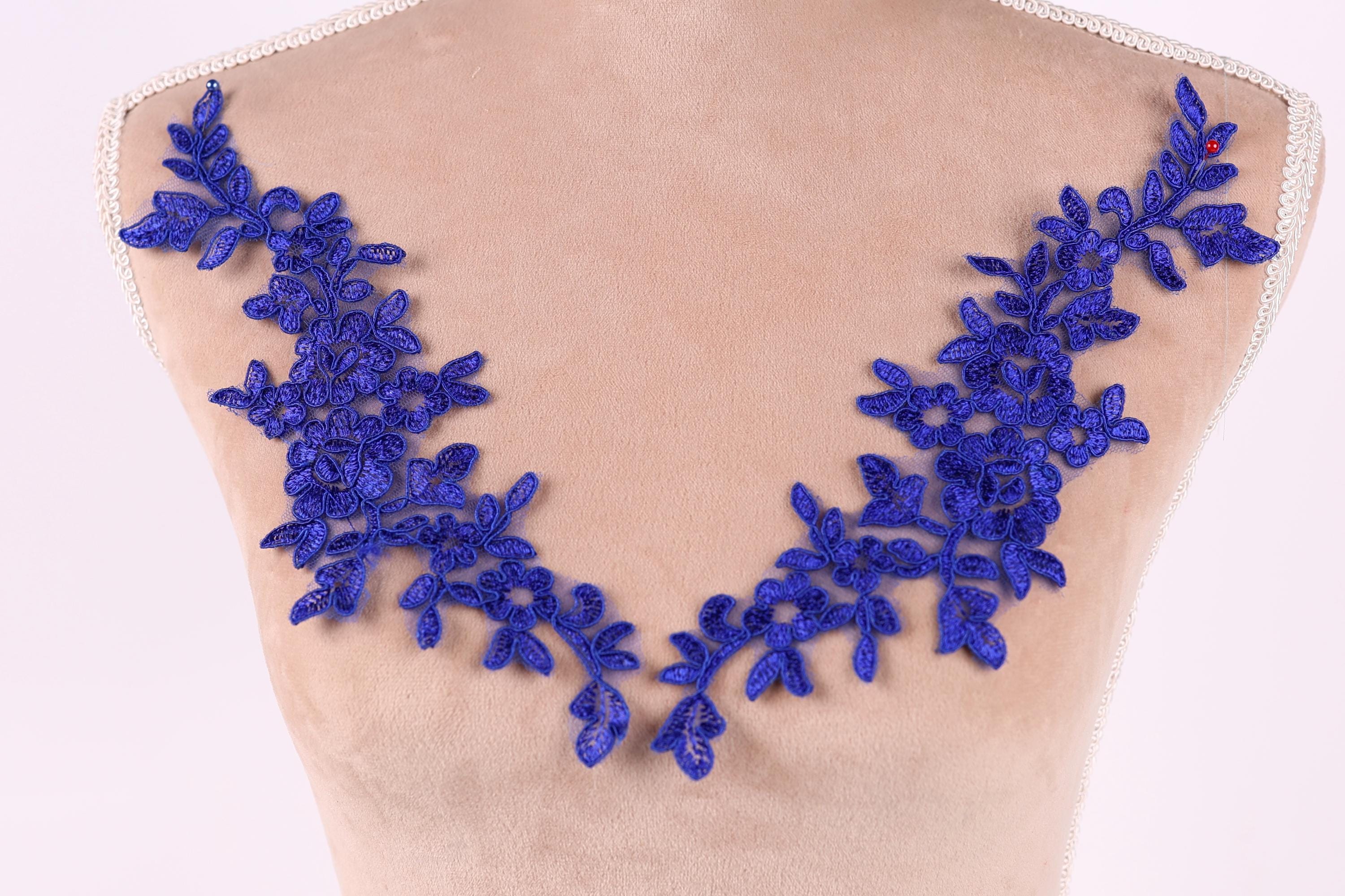 a mannequin torso with a decorative blue lace overlay on it.