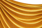 a close-up view of a shiny, golden-colored fabric, possibly velvet, with a smooth, flowing texture.