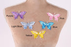 a mannequin torso with five colorful butterfly patches on it, each with a different color and design.