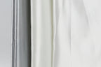 a close-up view of three fabric swatches, with the middle one being white and the other two being gray.
