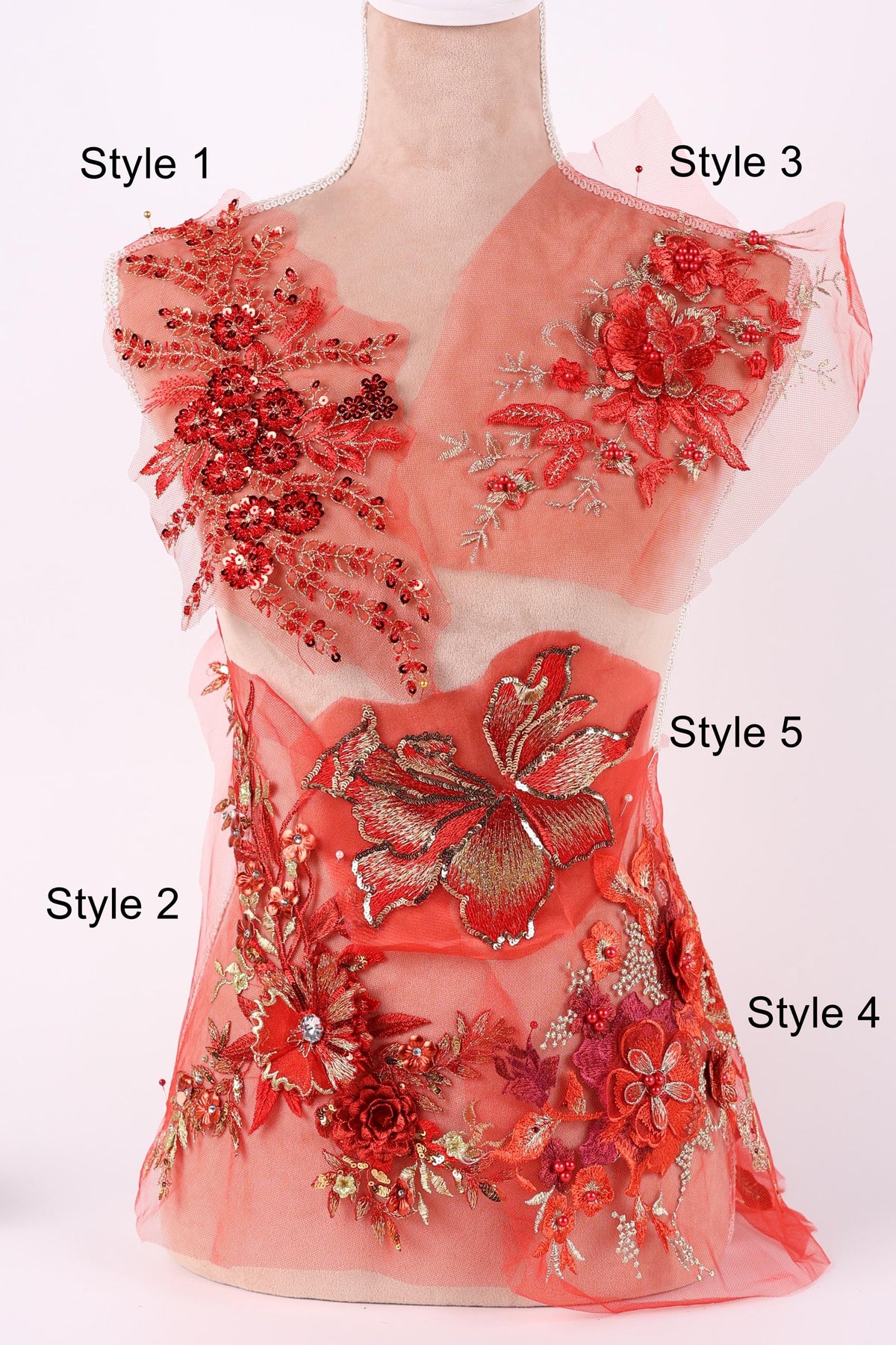 A mannequin with a red floral dress on display, featuring various styles of floral embroidery and embellishments.
