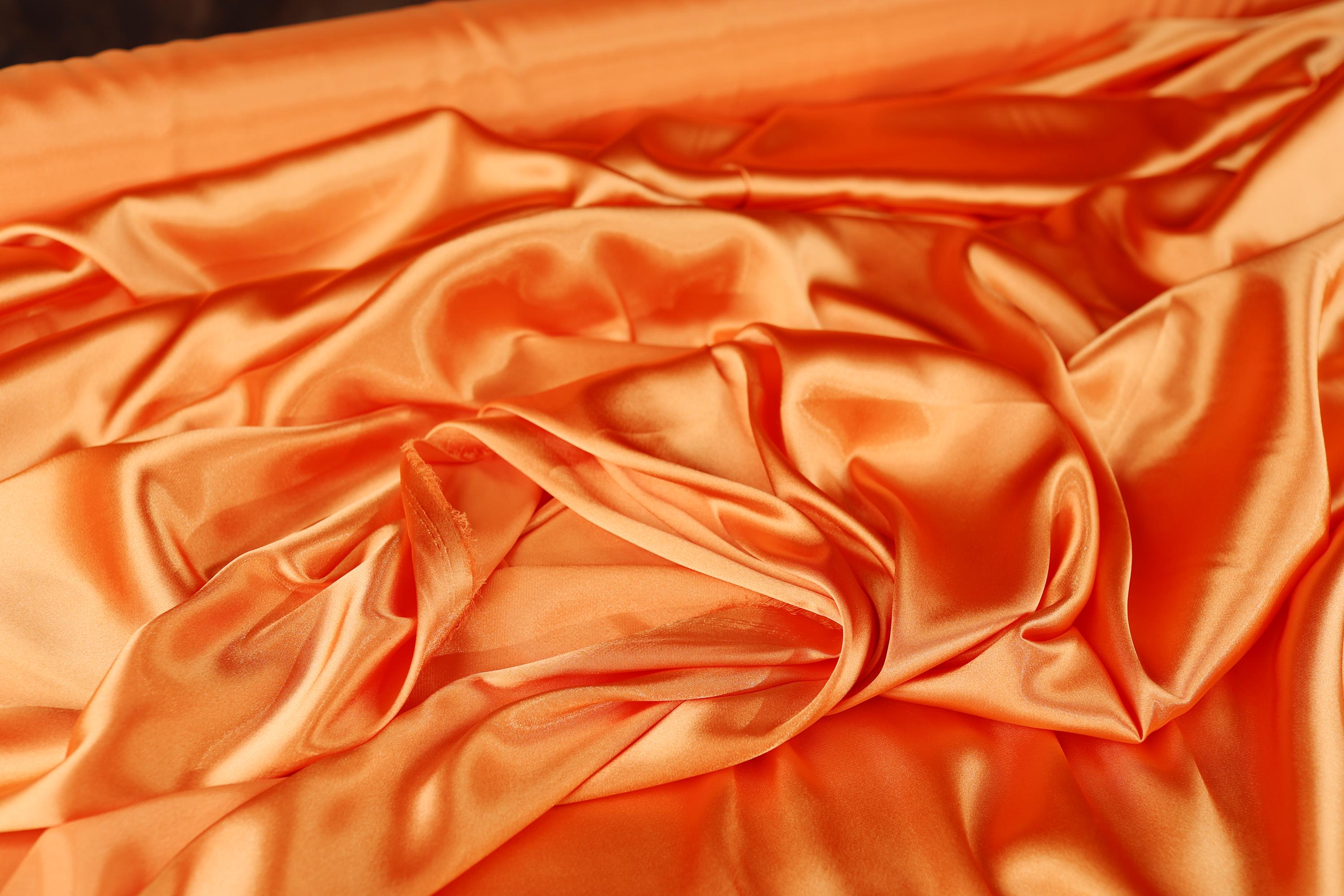 a close up of an orange satin material