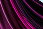 a close-up view of a fabric with a purple and pink color gradient, creating a visually striking and vibrant pattern.