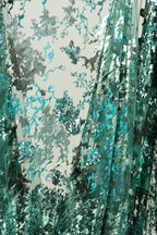 The image is a collage of various images, featuring a mix of textured and patterned elements. The predominant colors are green and blue, creating a visually striking and abstract composition.