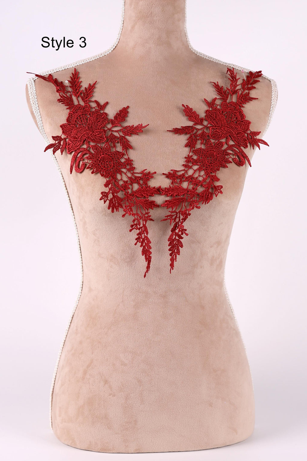 A mannequin with red floral embroidery on its bust area.