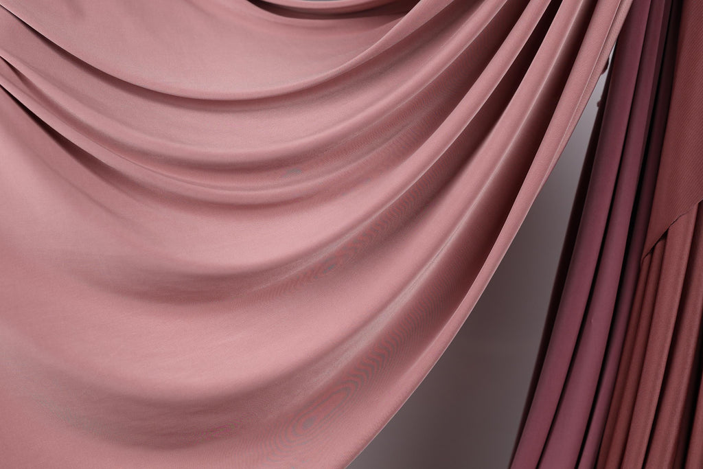 a close-up view of a soft, flowing pink fabric, possibly a curtain or textile. The fabric has a smooth, wavy texture and appears to be made of a soft, plush material. The image does not contain any discernible objects or actions, and there are no specific actions or objects that can be described in detail. The image is a simple, uncluttered composition that focuses on the texture and color of the fabric.