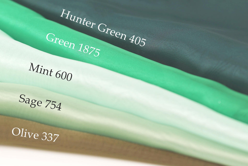 A close-up of a stack of fabric swatches, each with a different color and size, labeled with their respective names.