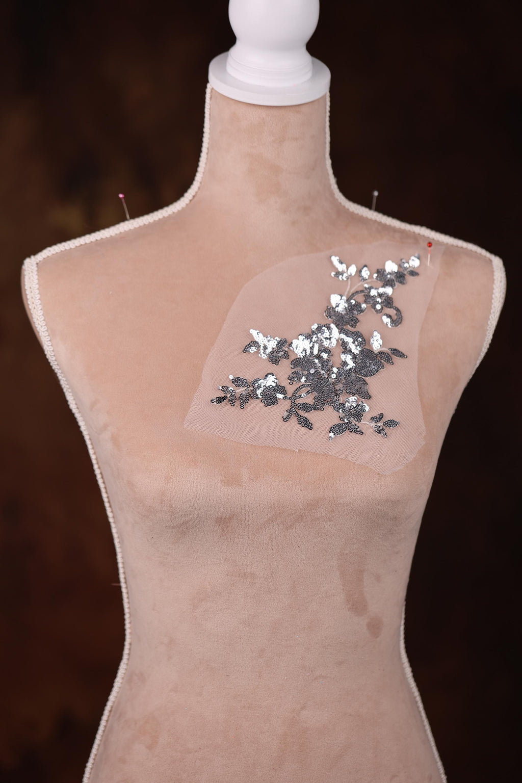 a mannequin with sequins and a piece of plastic