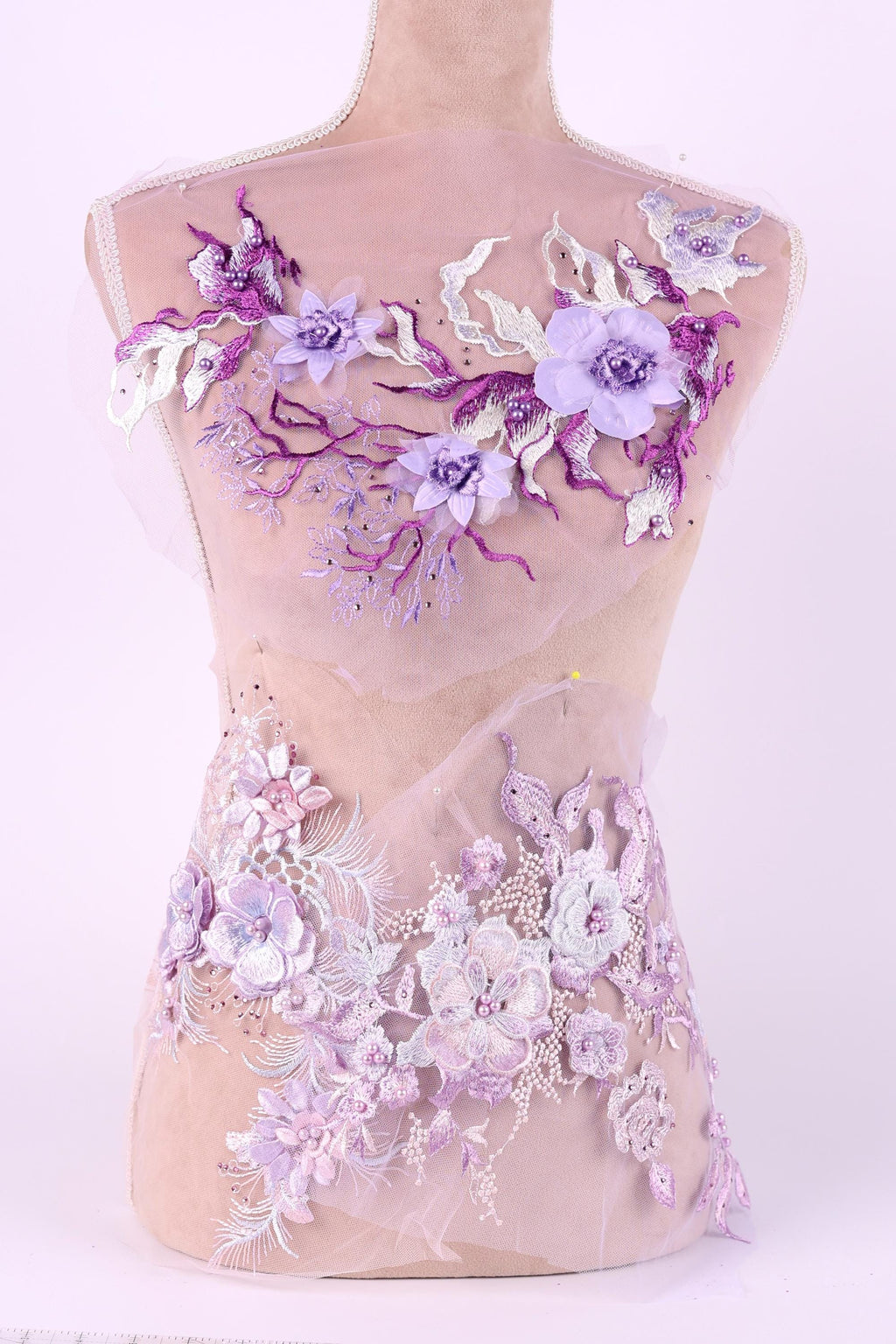 A mannequin wearing a dress with a floral pattern in shades of purple and white.